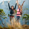 two young females celebrating at top of a summit hiking two_female_hikers_celebrating_a_summit