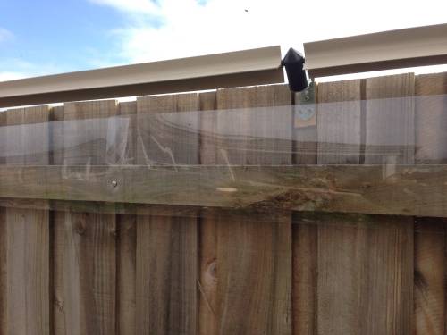 Wooden cat fence with Oscillot cat containment solution
