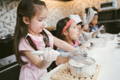 Group of little girls baking pastry.