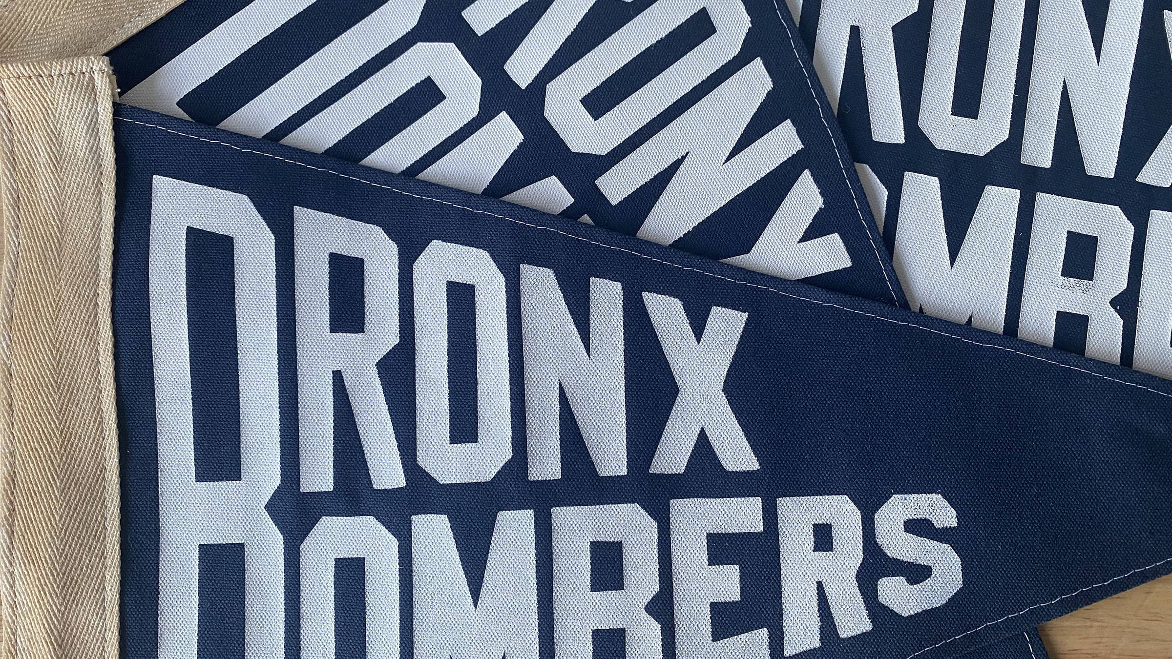 Several Bronx Bombers pennants in a pile.