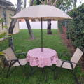 pink damask outdoor tablecloth on a round table
