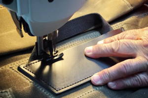 close up of sewing a piece of leather