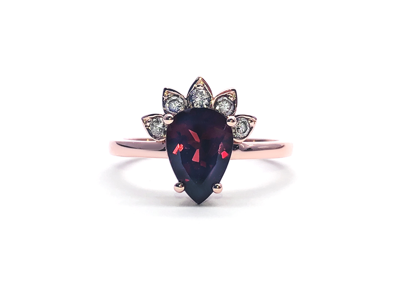 rose gold ring with pear cut garnet and five diamonds