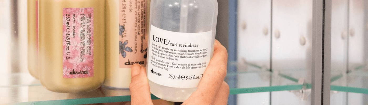 mini OI shampoo, OI milk, OI conditioner inside a packed suitcase