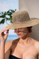 woman wearing a straw hat to avoid sun damaged skin