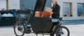 Woman loading boxes into Urban Arrow electric cago bike