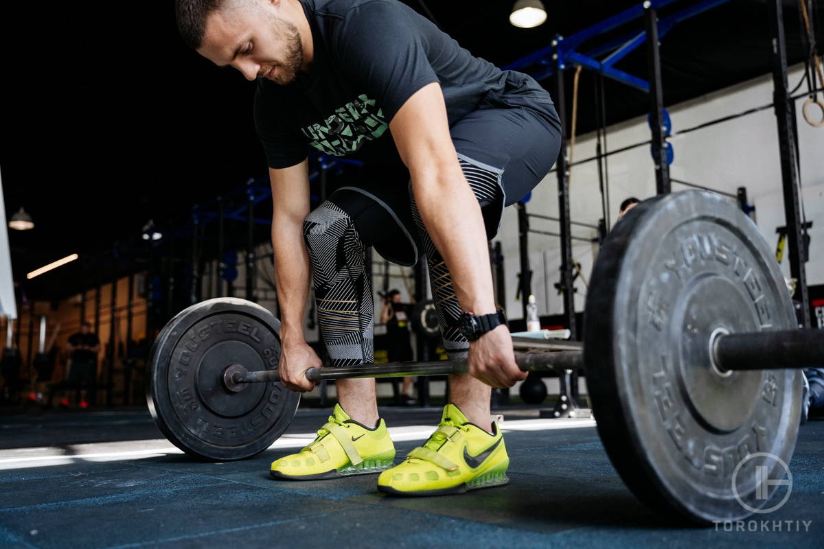 athlete in black training with barbell