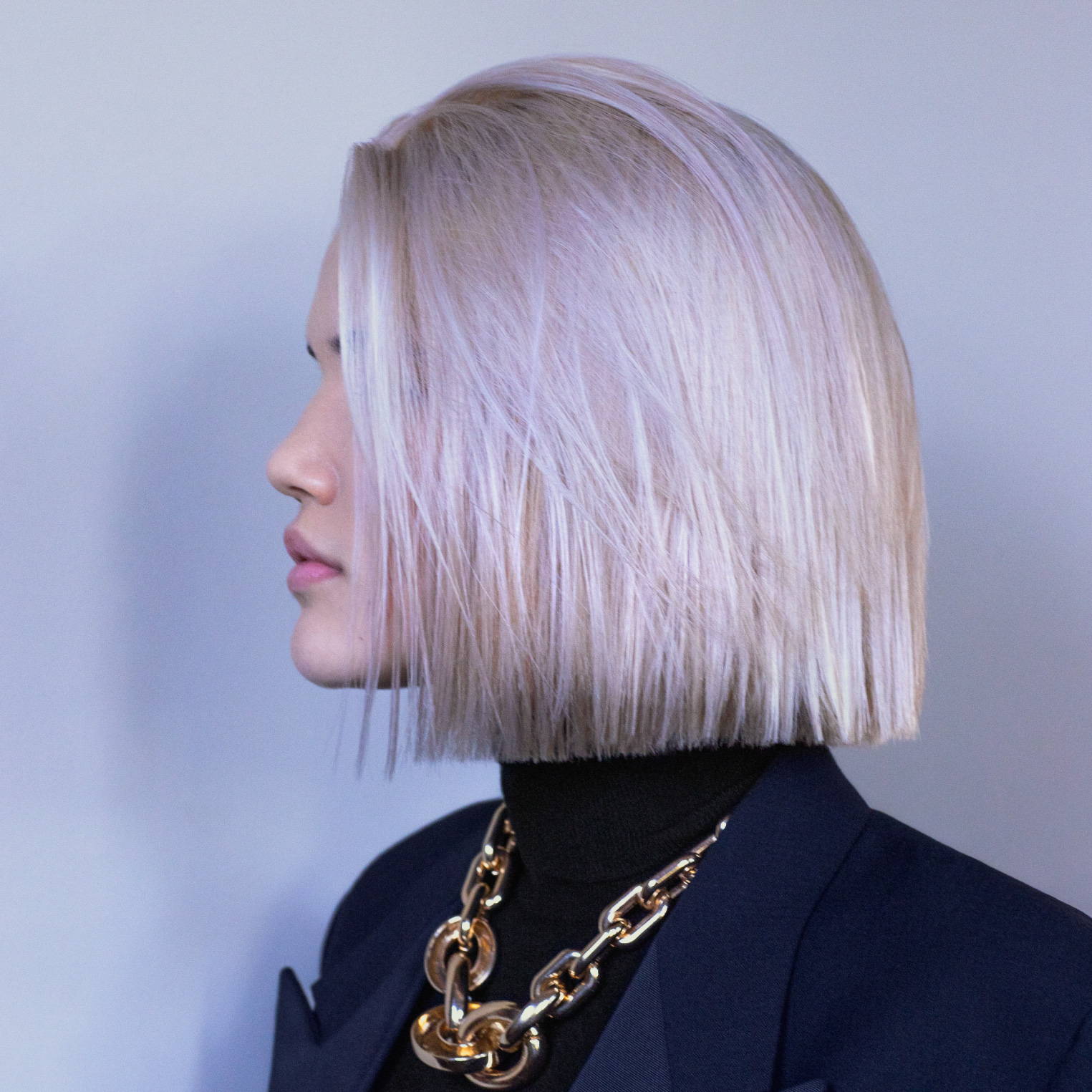side view of a woman with a platinum bob hairstyle