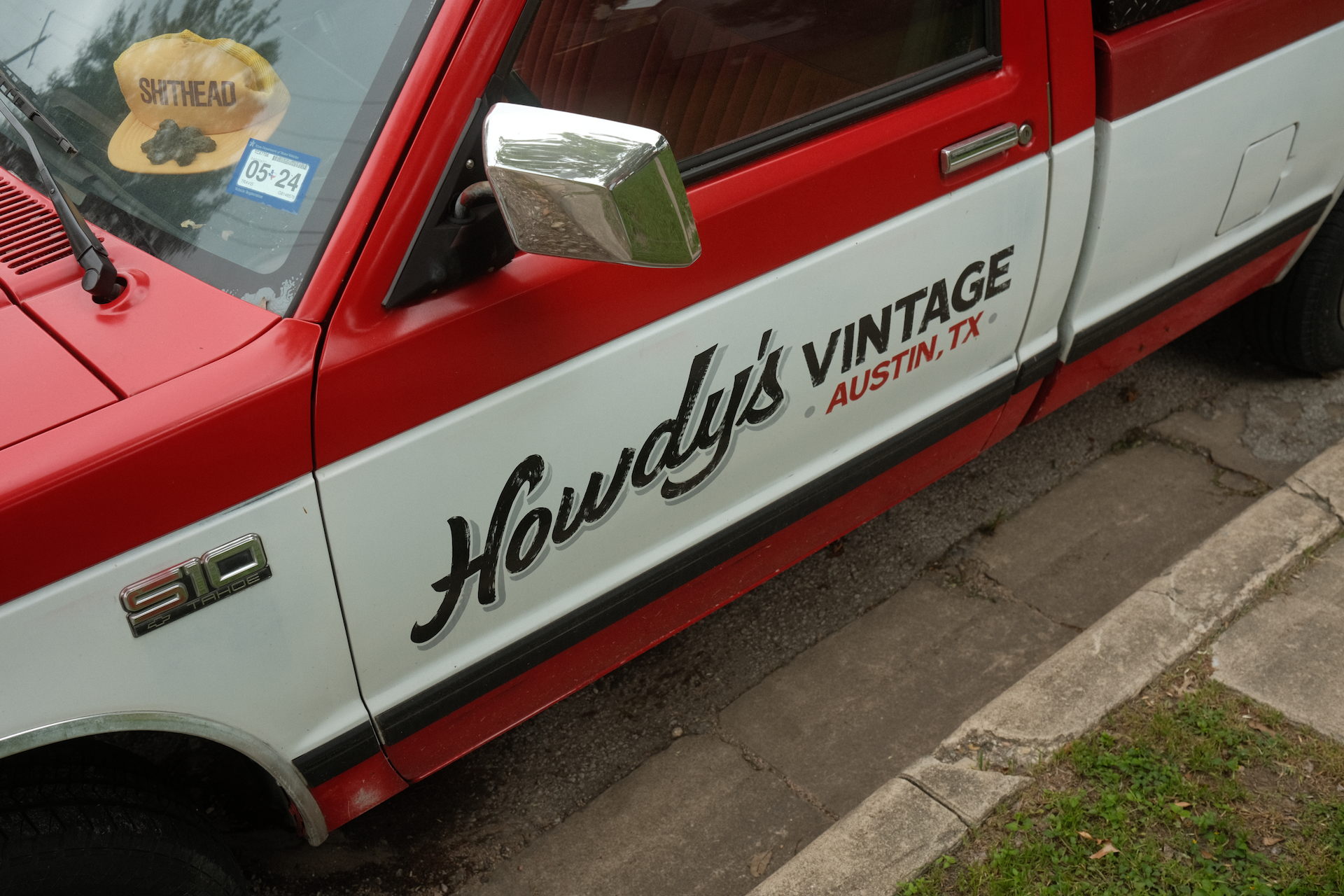 A red truck with the word 'Howdy' on the side, parked near Manor in Austin, Texas