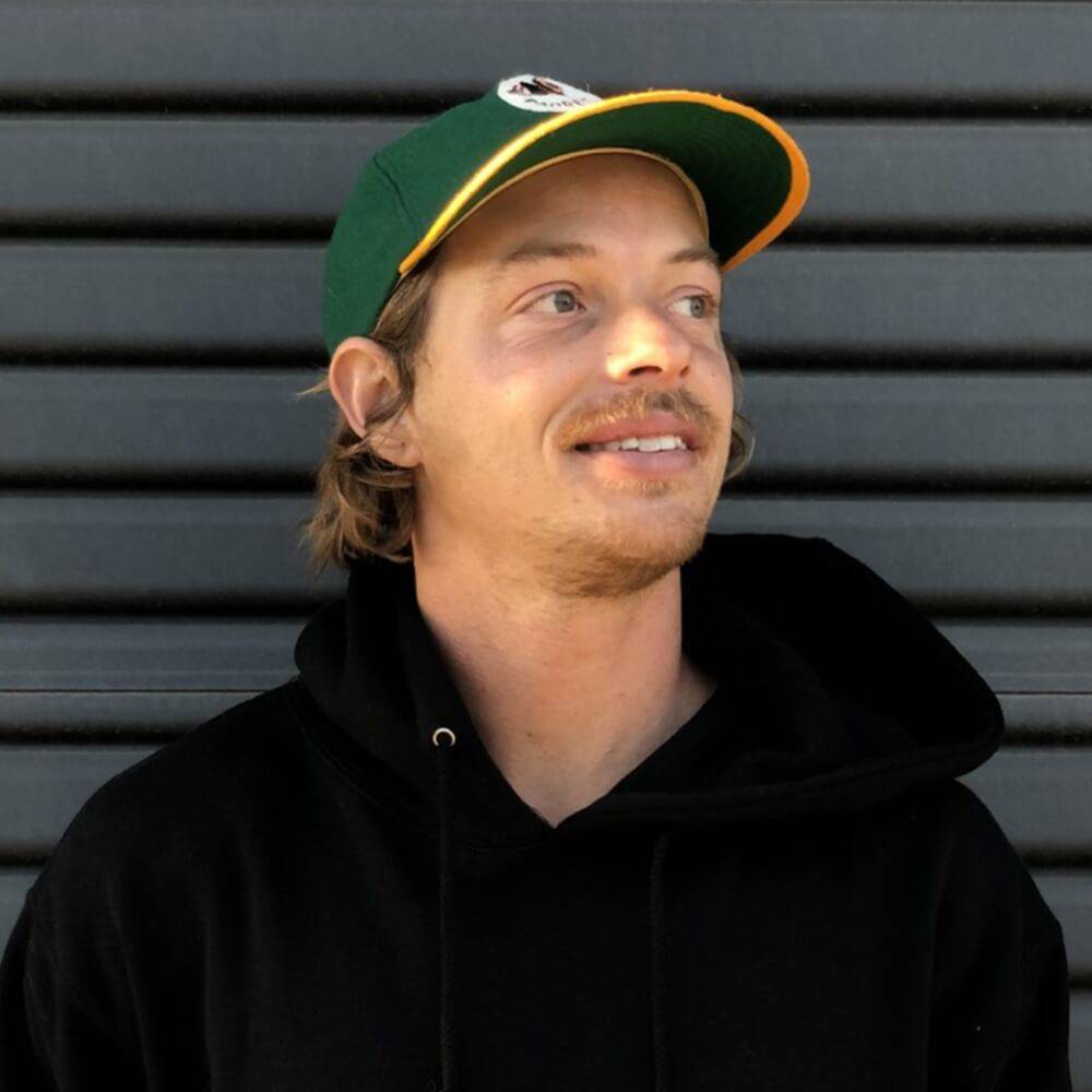 Nathan wearing a green and yellow hat with a black jacket