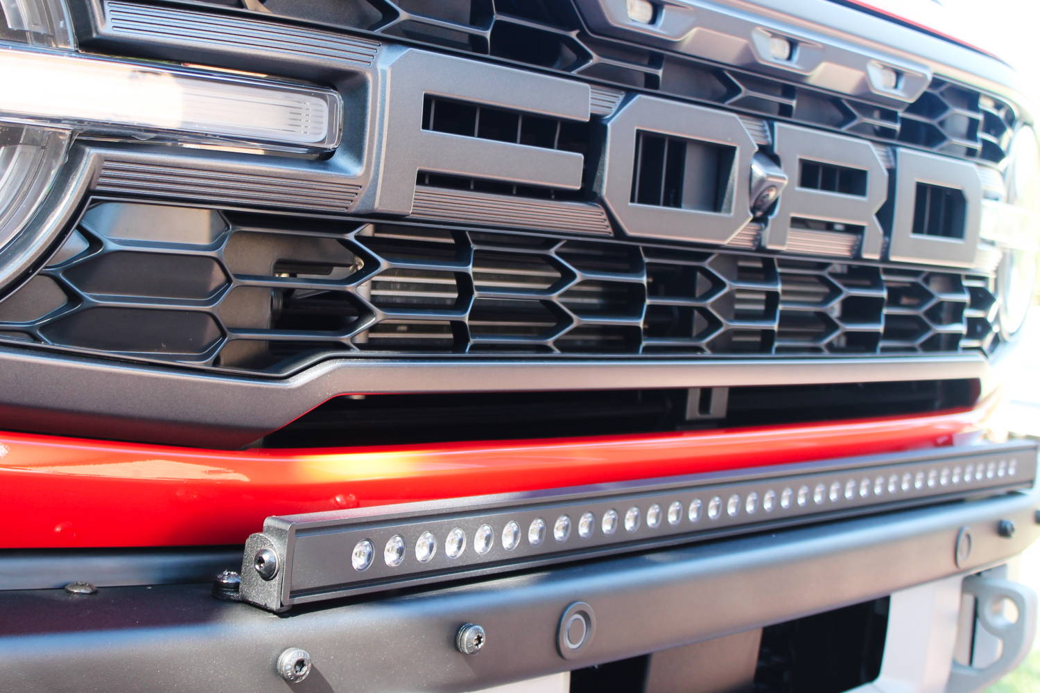 white 40in led light bar on top of bumper for off roading on ford bronco raptor