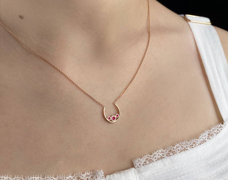 Pink gold pendant with pink saffires subtly reminiscent of a breast. Designed for breast cancer research.