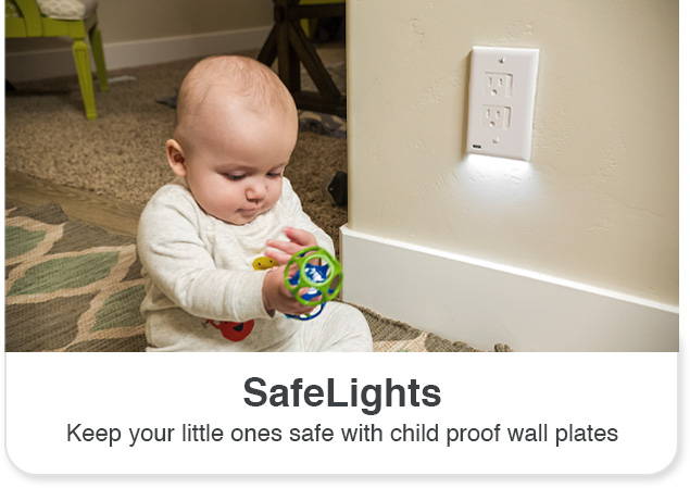 Baby holding toy sitting on the ground next to a SafeLight outlet light cover