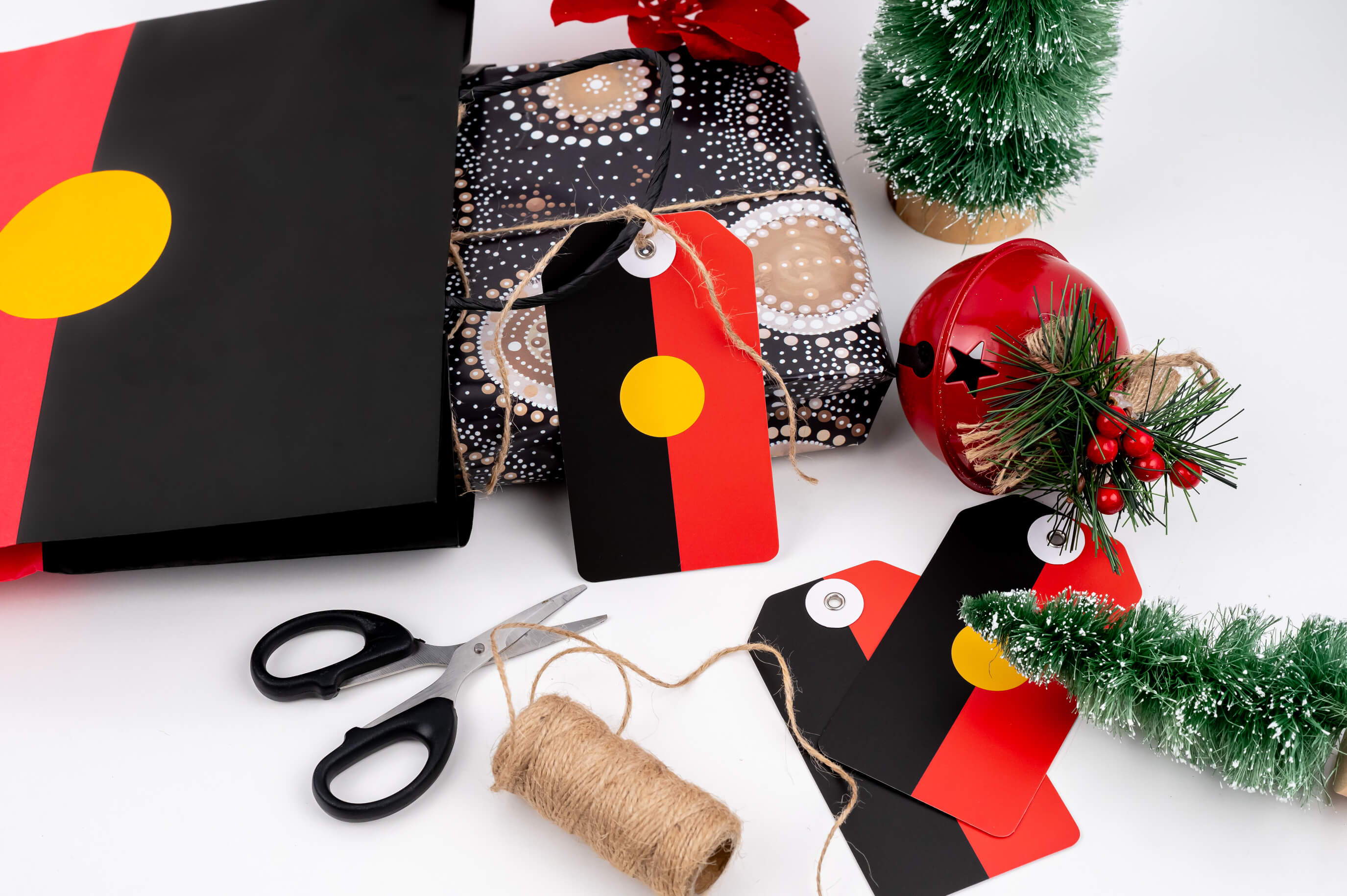 Gift wrapping with Aboriginal flag design with Christmas decorations