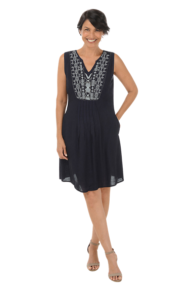 A woman wears a navy blue embroidery pleated sleeveless linen dress.