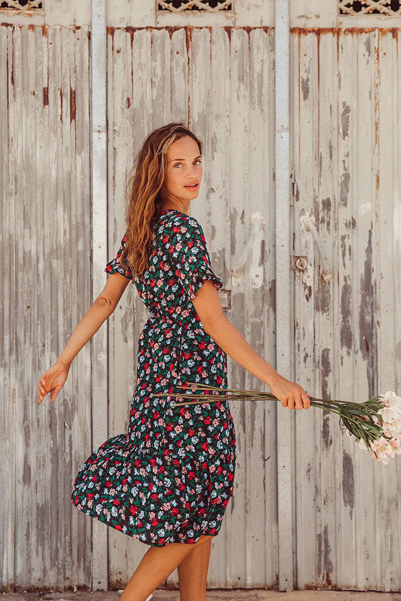 Anastasia Yakhnina Twirls in YOLKE's Colette Folktails Dress whilst holding flowers