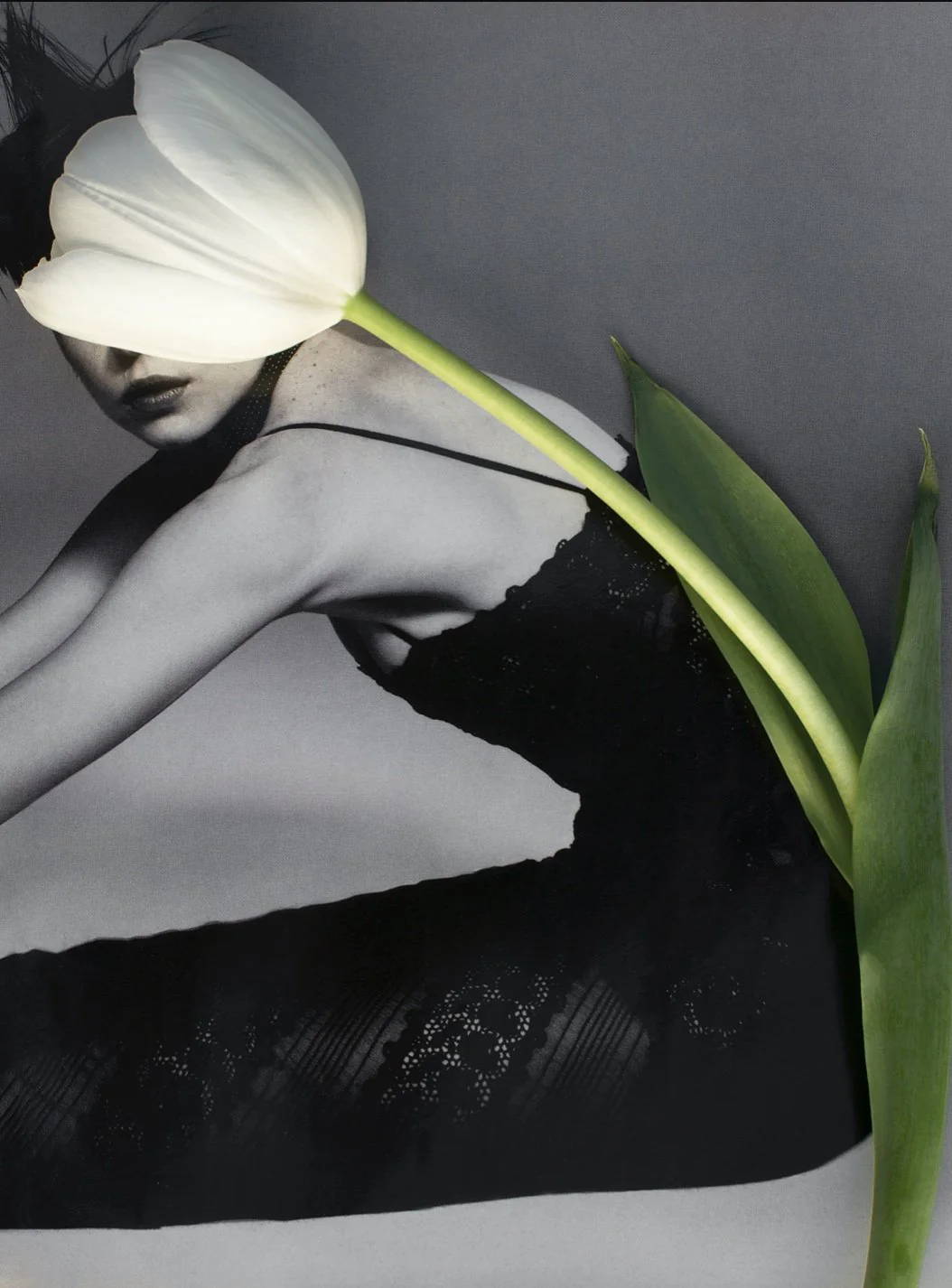 'Round & Round' - by Dina Broadhurst - A black and white photographic print embellished with a white tulip over a figure in a black dress