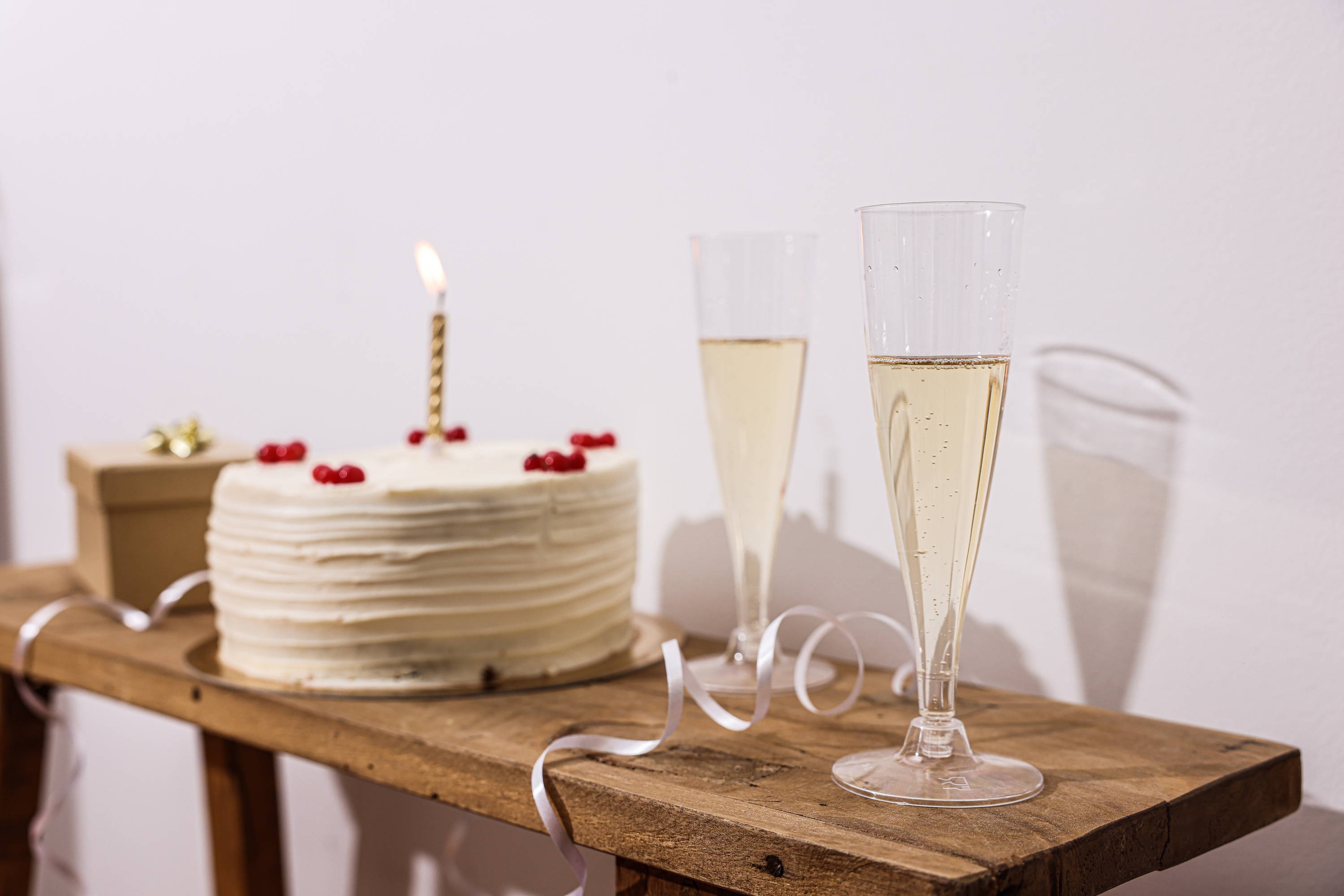 Sparkling wine alongside a birthday cake.  