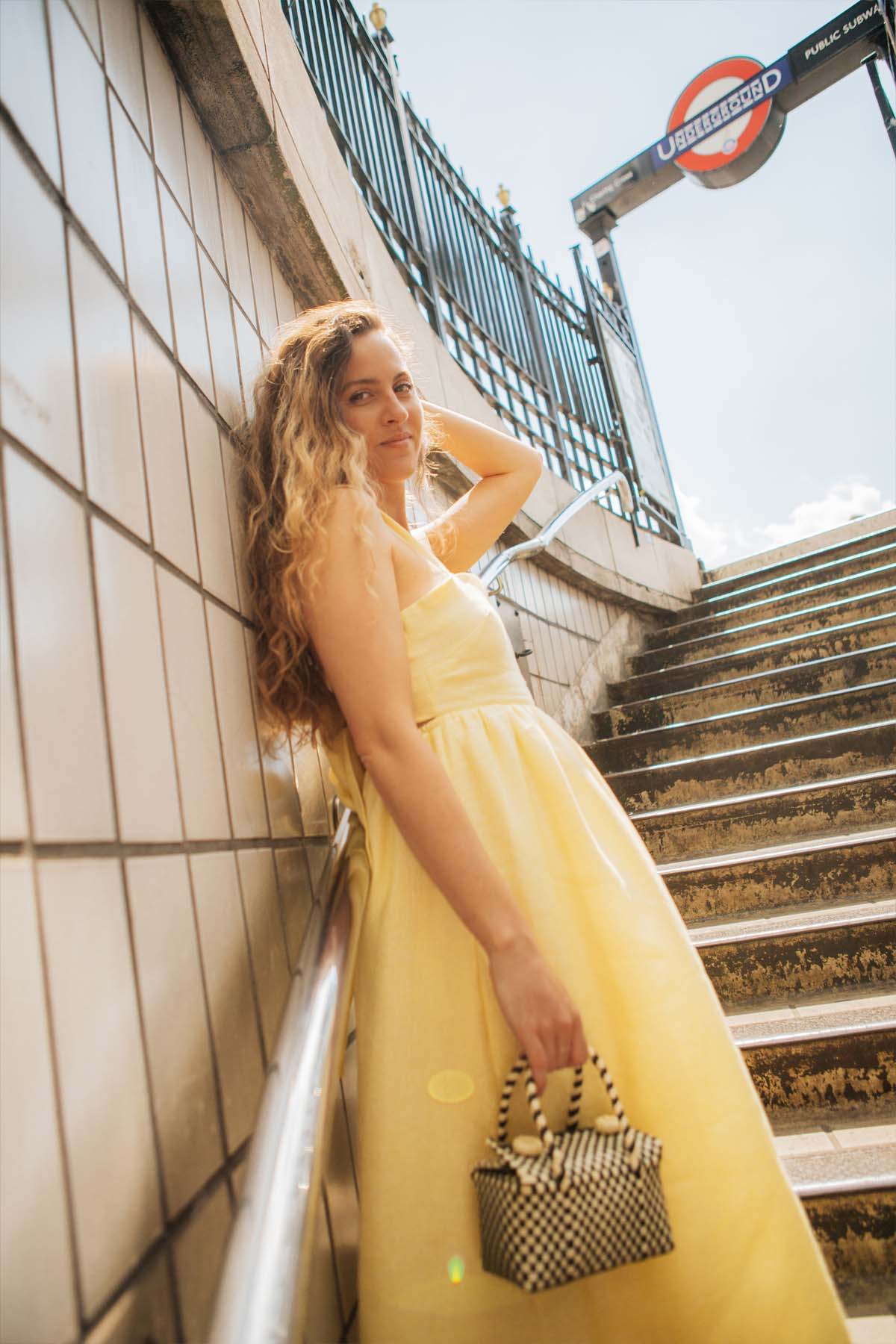 Honey Simmonds wears Yolke sparkly yellow open back bow sun dress