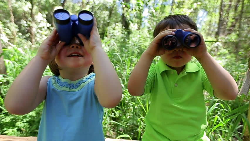 Two kids looking through binoculars