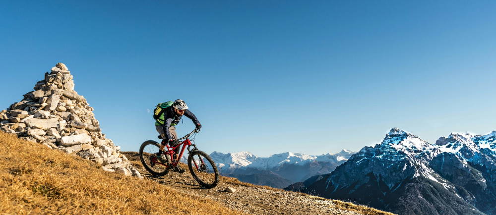 an electric mountain biker riding in the wilderness