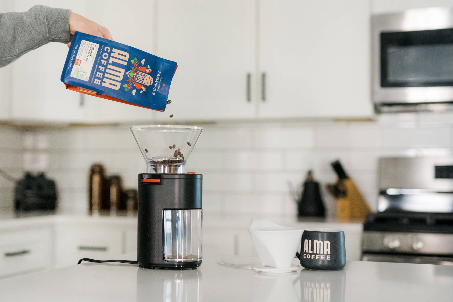 Pouring whole bean coffee into grinder