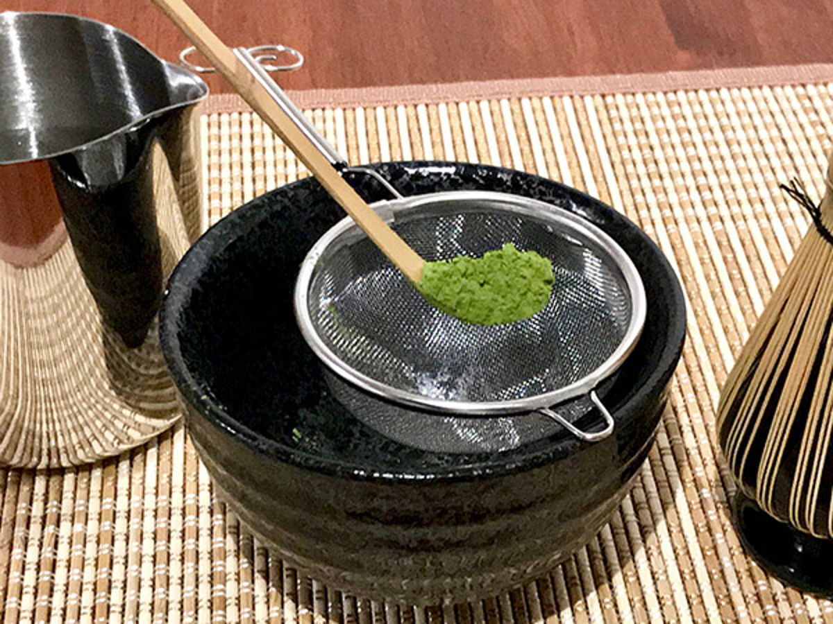 Add matcha tea powder into fine mesh sieve