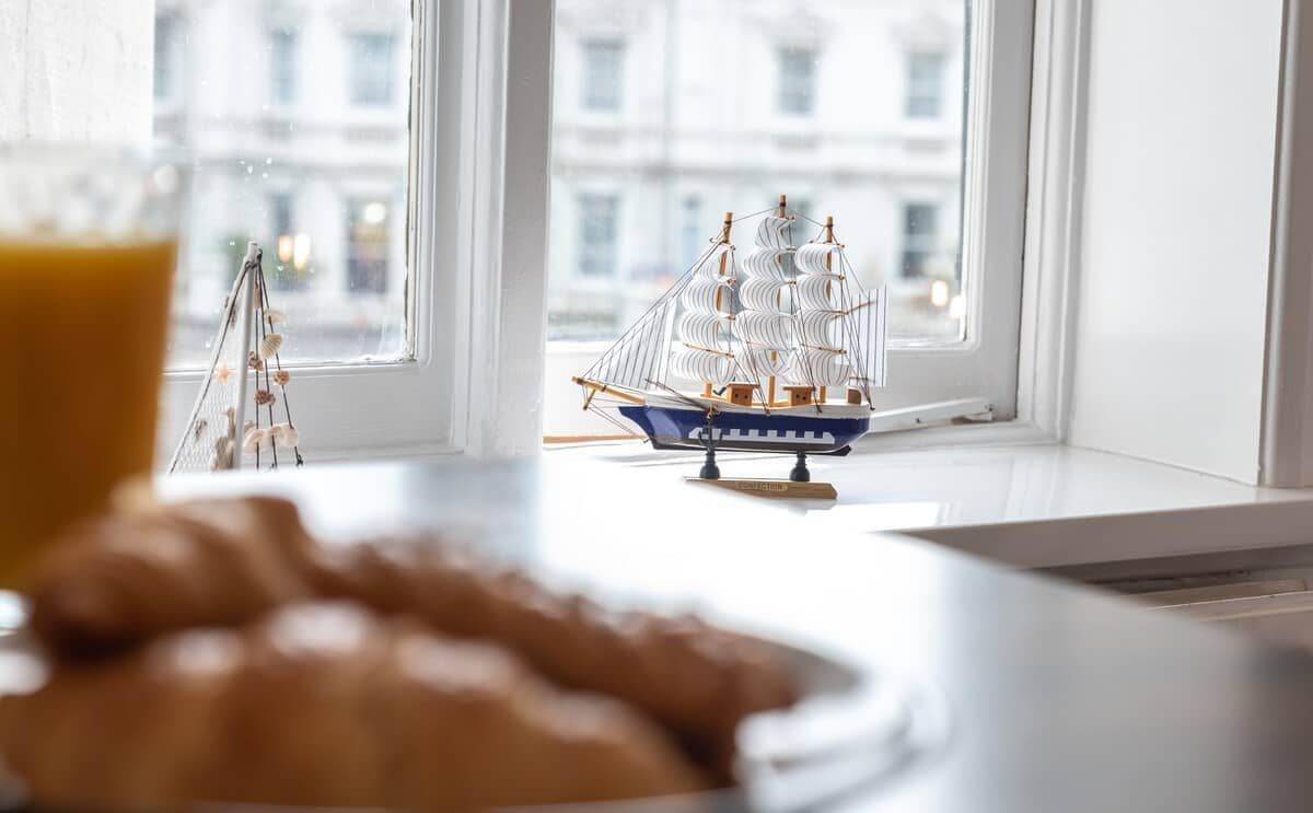 View of a window with a decorative small boat in front of it