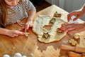 Mother and daughter making cookies on a kitchen table.