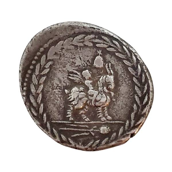 Ancient Roman Republic silver coin of winged genius riding a goat surrounded by a laurel wreath.