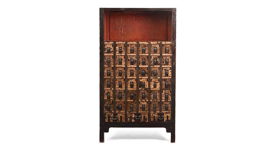 Detail from one of a pair of antique black lacquer wedding cabinets with painting of lucky symbols and original brass from the Qing dynasty. 