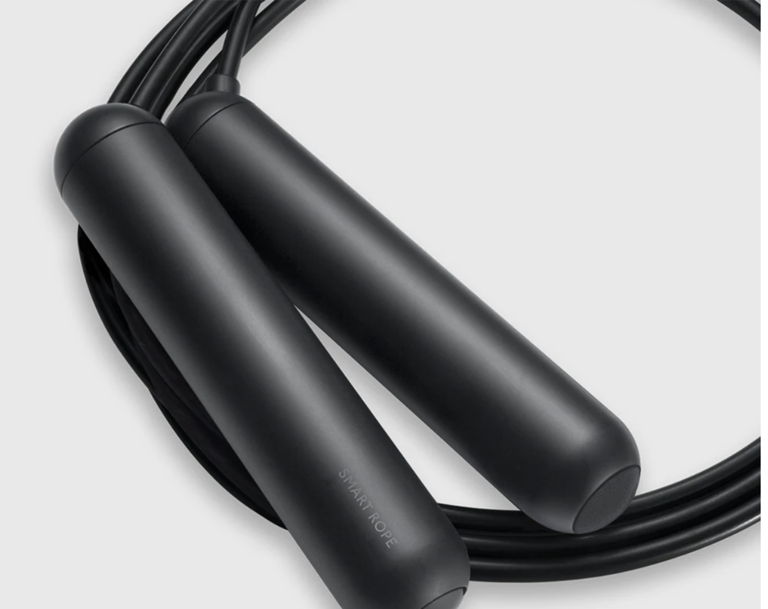 a black Tangram Smart Rope curled up into a circle