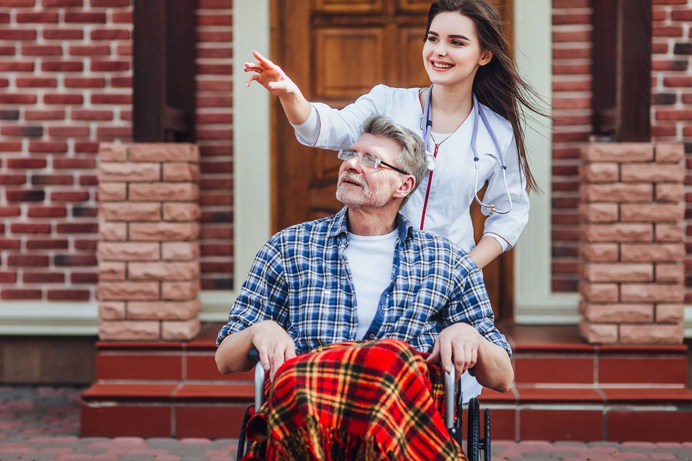 nurse with old man in wheelchair