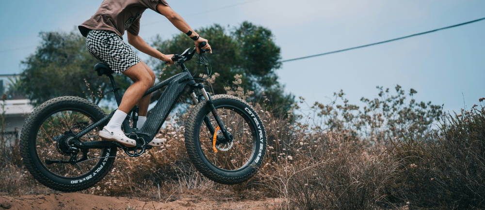 a man jumping a himiway electric bike