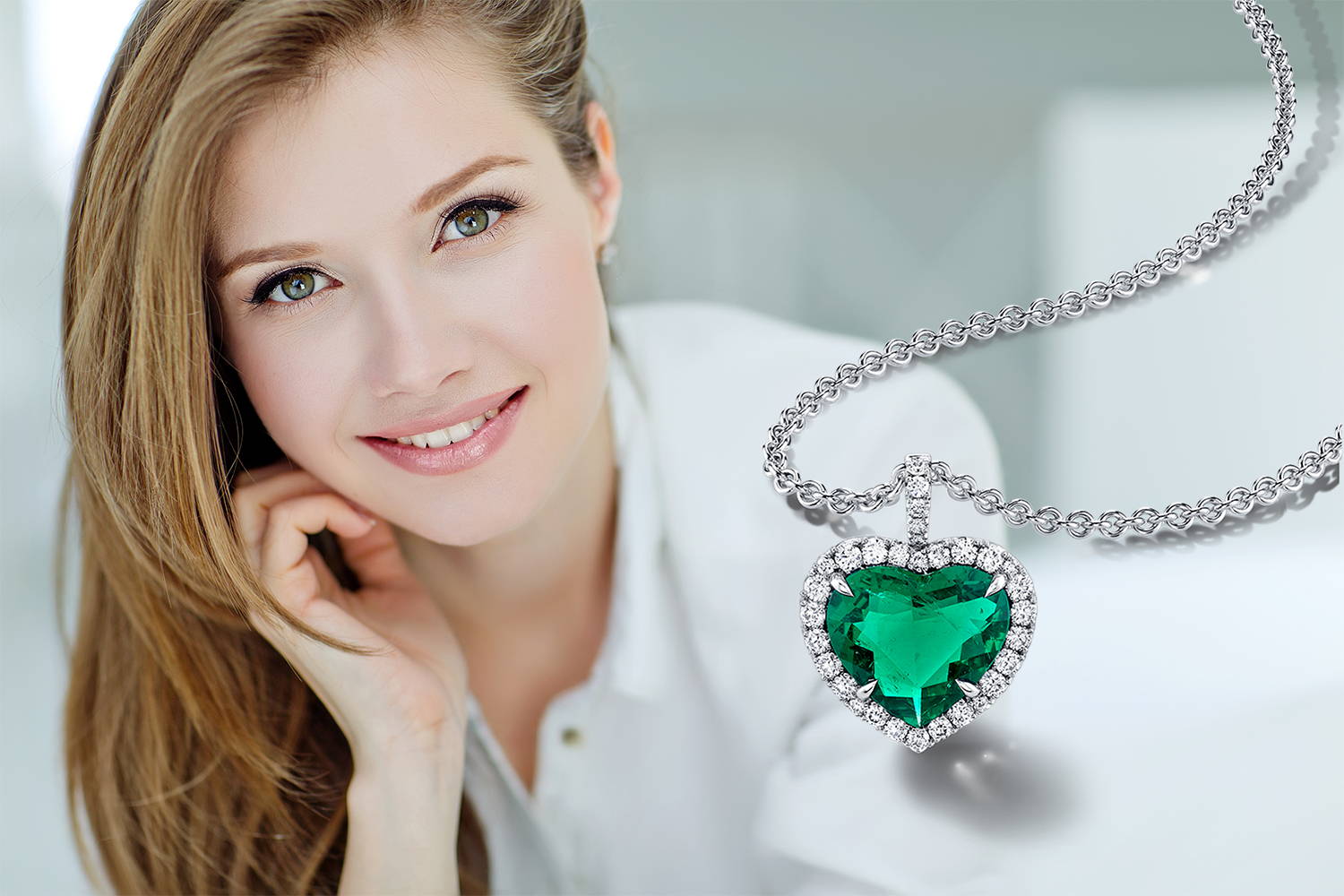 model with heart shaped emerald and diamond necklace