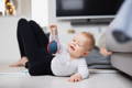 Baby playing with a soft rattle toy.