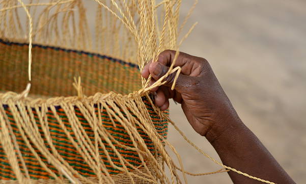 Hands on detail of Bolga basket weaving and african moses baskets