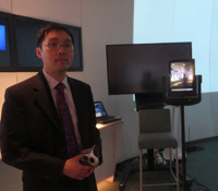 Al Lee personifies a Fidelity determination to straddle humans and the software and hardware that serves them. Here he stands with an early-stage robot.