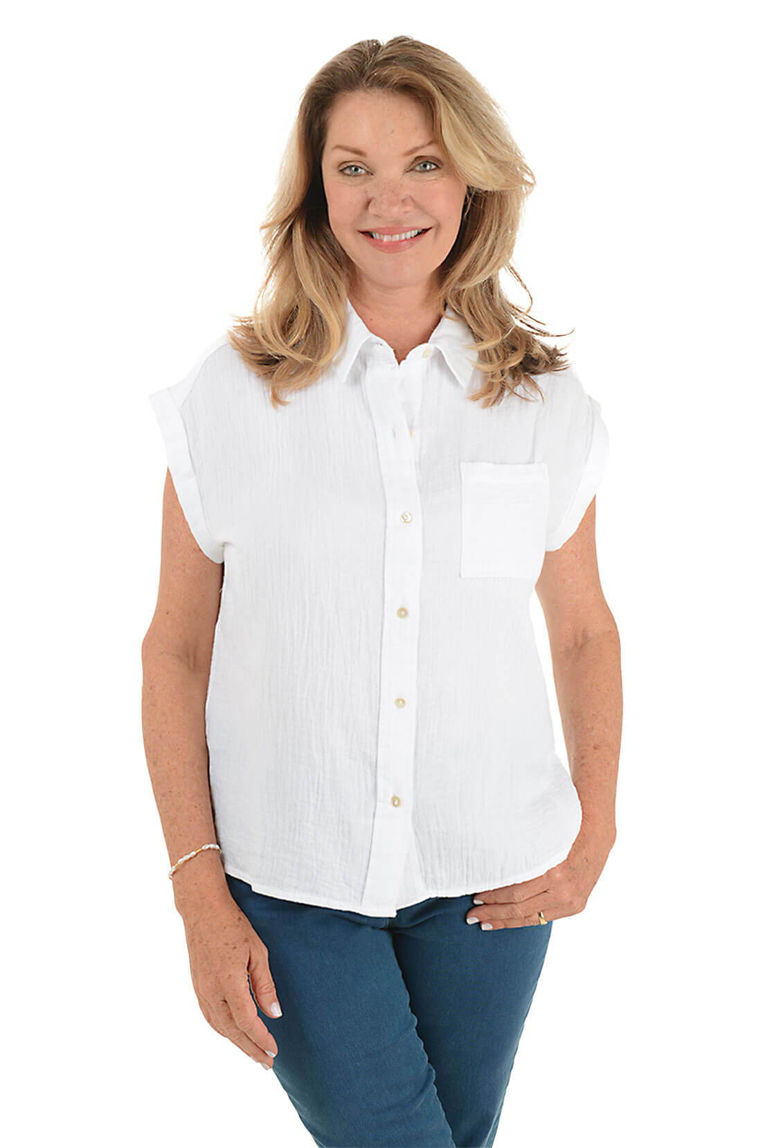 A woman wears a white cotton gauze shirt.