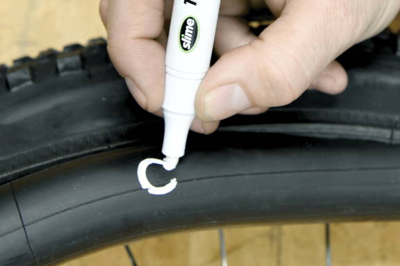 Marking a Puncture with a Tire Pen on a Tube