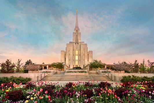 Oquirrh Mountain Temple surrounded by colorful flowerbeds. 