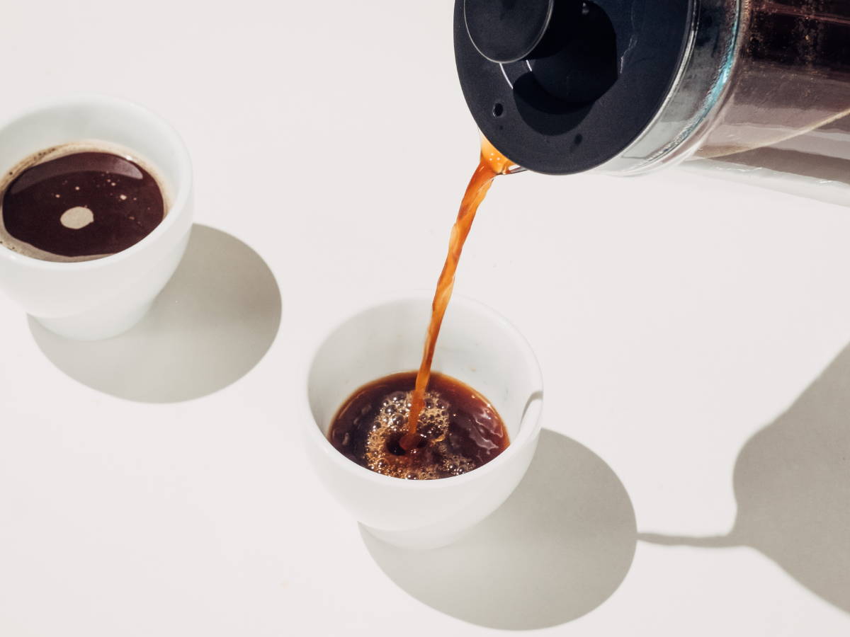 Black coffee pouring into mug.
