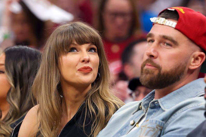 Image may contain: Taylor Swift, Travis Kelce, Head, Person, Face, Blonde, Hair, Adult, Happy, Smile, Body Part, and Neck