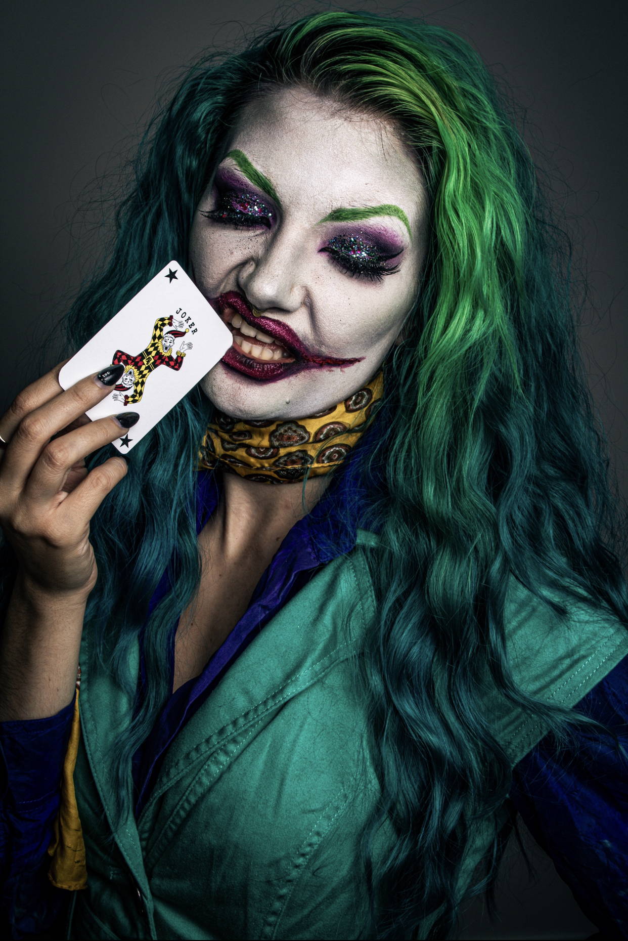 Image shows a halloween cosplay of the joker using biodegradable bioglitter to finish off the make-up look.