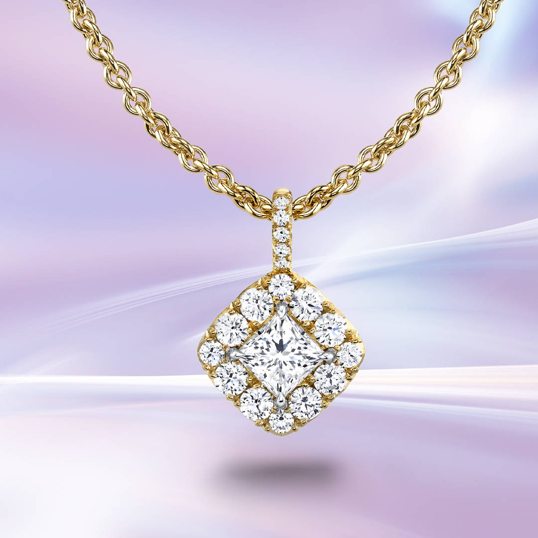 Princess cut pendant with diamond halo in yellow gold on a purple background.