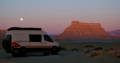 Camper Vans gathered at a campfire at sunset