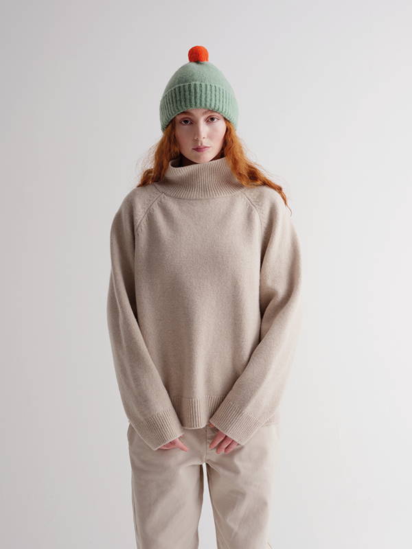 model wears Brushed Plain Hat Contrast Pompom Sage & Orange Gloss