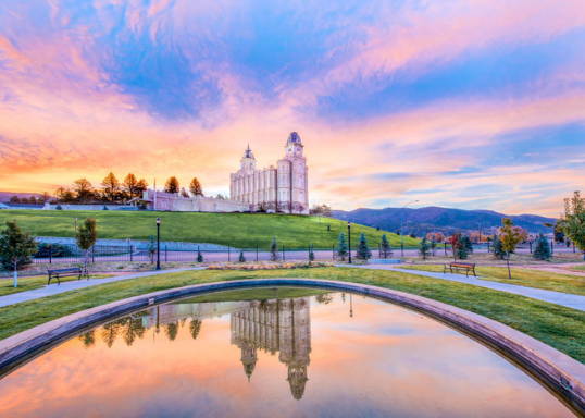 A picture of a reflection pool reflecting the Manti Utah Temple in the distance.