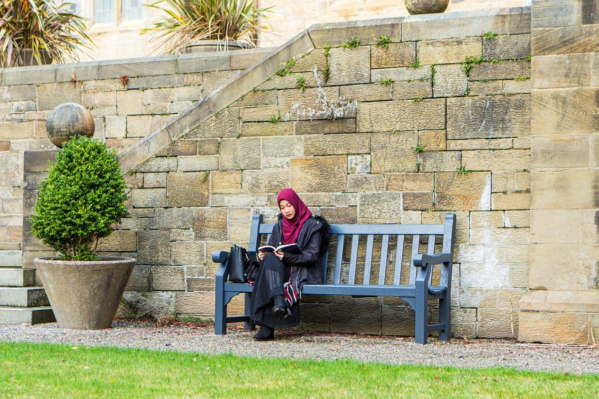 Student studying on a bench at Bangor university