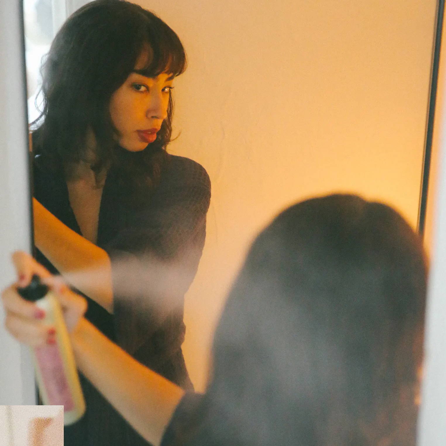 woman using Davines This is a Shimmering Mist